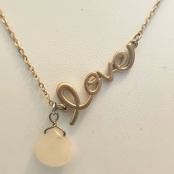 Elegant Gold Necklace with Milk Glass Teardrop Pendant and Circular Accents - Picture 2 of 5